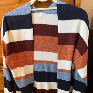 Super cute fall colors. No pockets or button closure. Super soft and cozy.